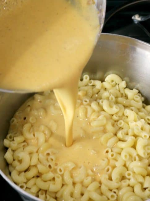 Stove Top Mac and cheese pour cheese sauce into the drained Pasta