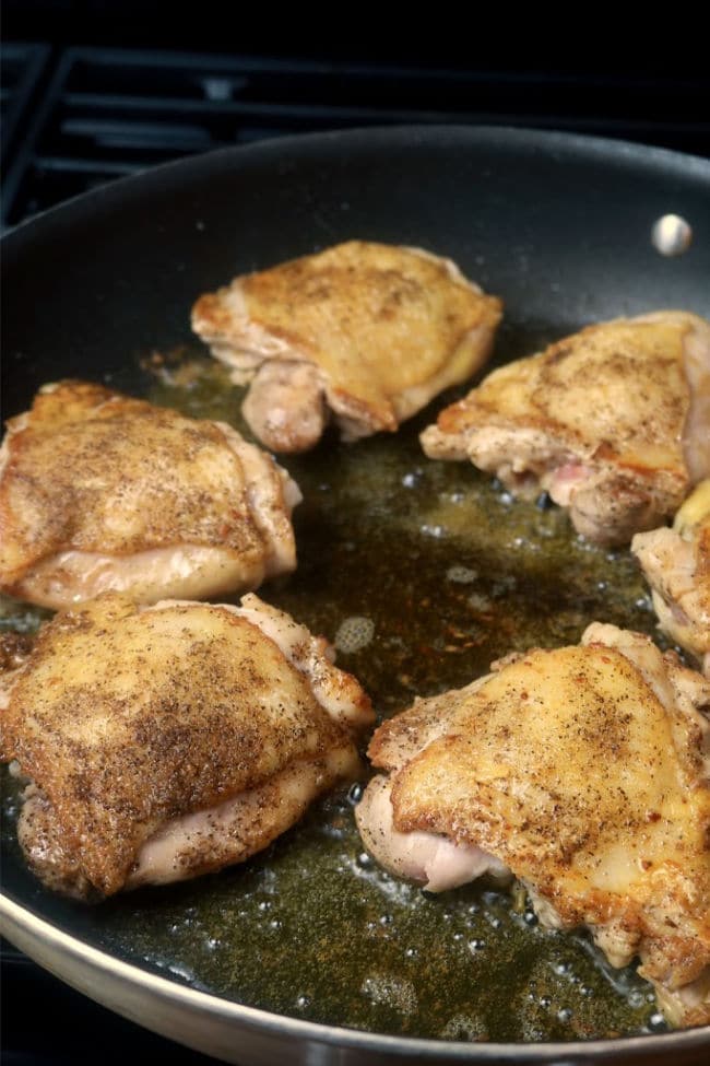 Chicken browning in a skillet.