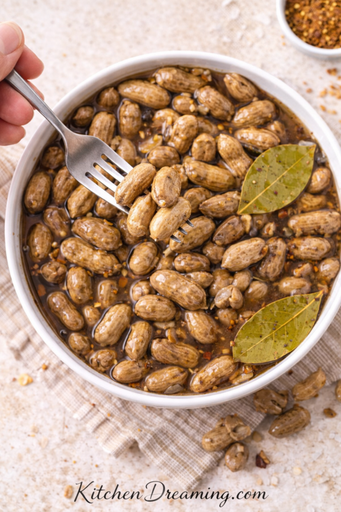 Crock Pot Boiled Peanuts (Easy Slow Cooker Recipe) 5 Overhead fork shot of crock pot boiled peanuts in seasoned brine.