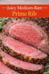 Close up of a juicy medium rare prime rib slice showing tender texture and herb crust.