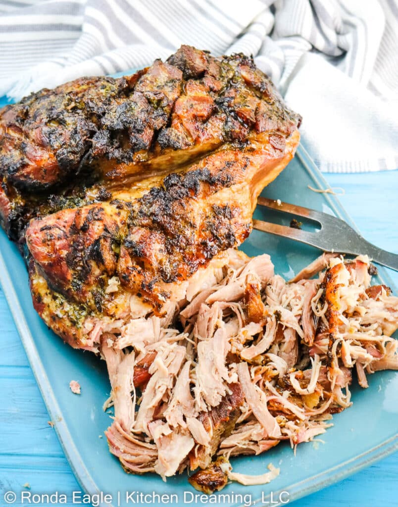 A serving platter of shredded Puerto Rican Pork Shoulder which is also called Pernil Adobo.