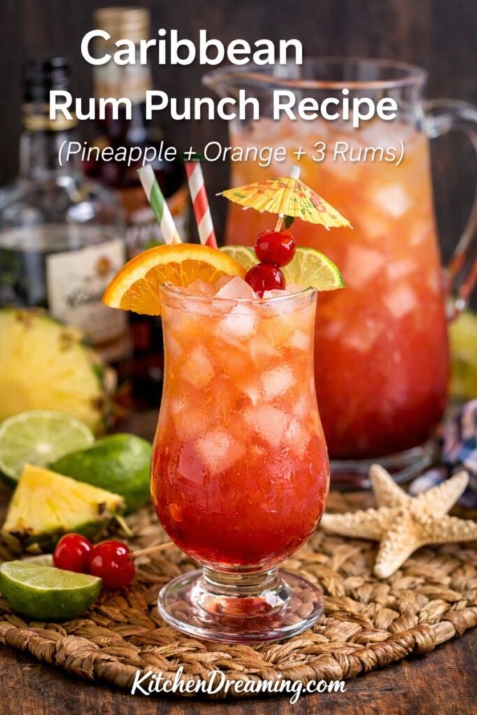 Caribbean Rum Punch Recipe served over ice in a hurricane glass with orange, lime, and cherries.