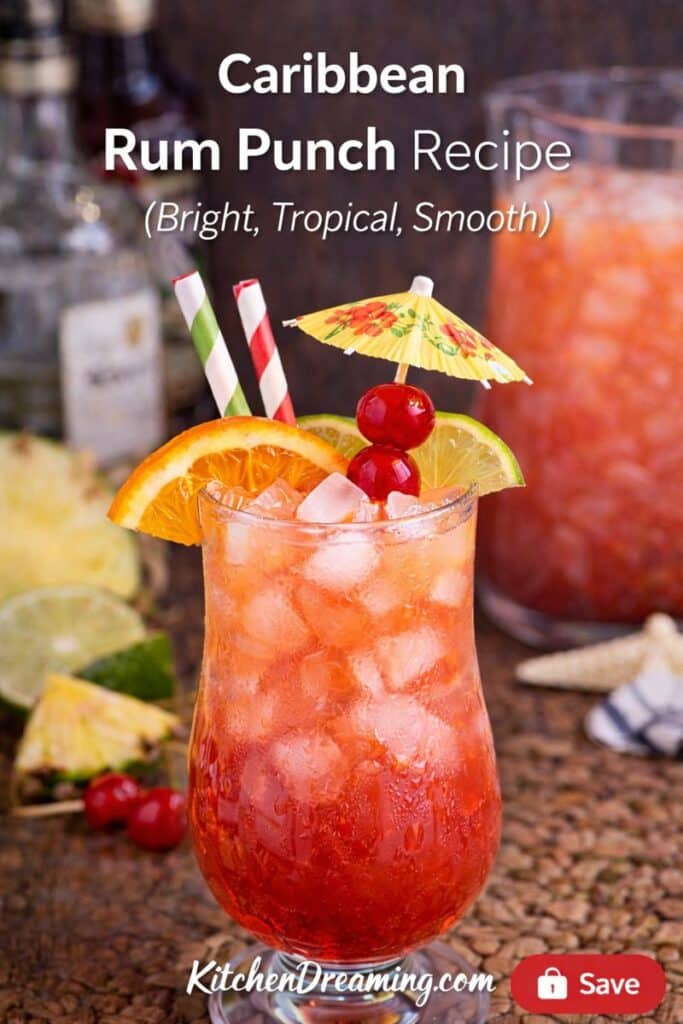Caribbean Rum Punch Recipe close-up with condensation, ice, and citrus garnish in a hurricane glass.