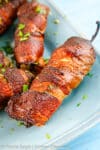 Smoked Jalapeno Poppers combines crispy bacon, roasted garlic cheese blend, and spicy jalapenos to create a mix of savory, smoky, and spicy flavors in every bite.
