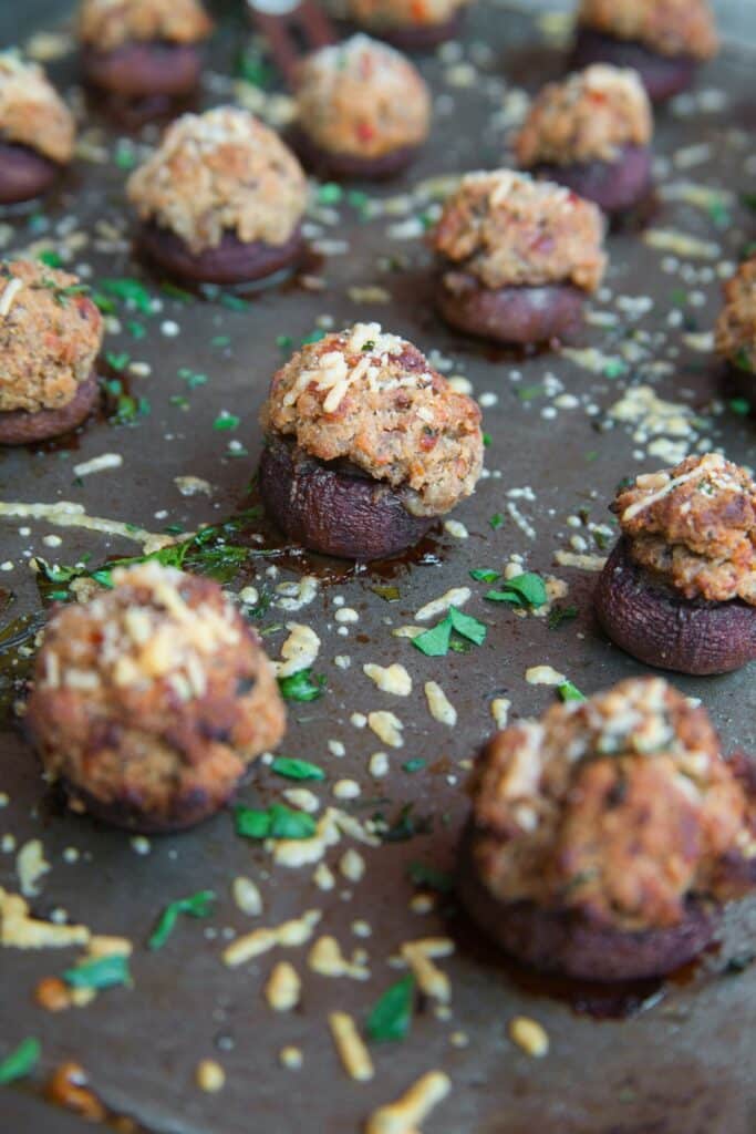 Cooked stuffed mushrooms on a party appetizer display.