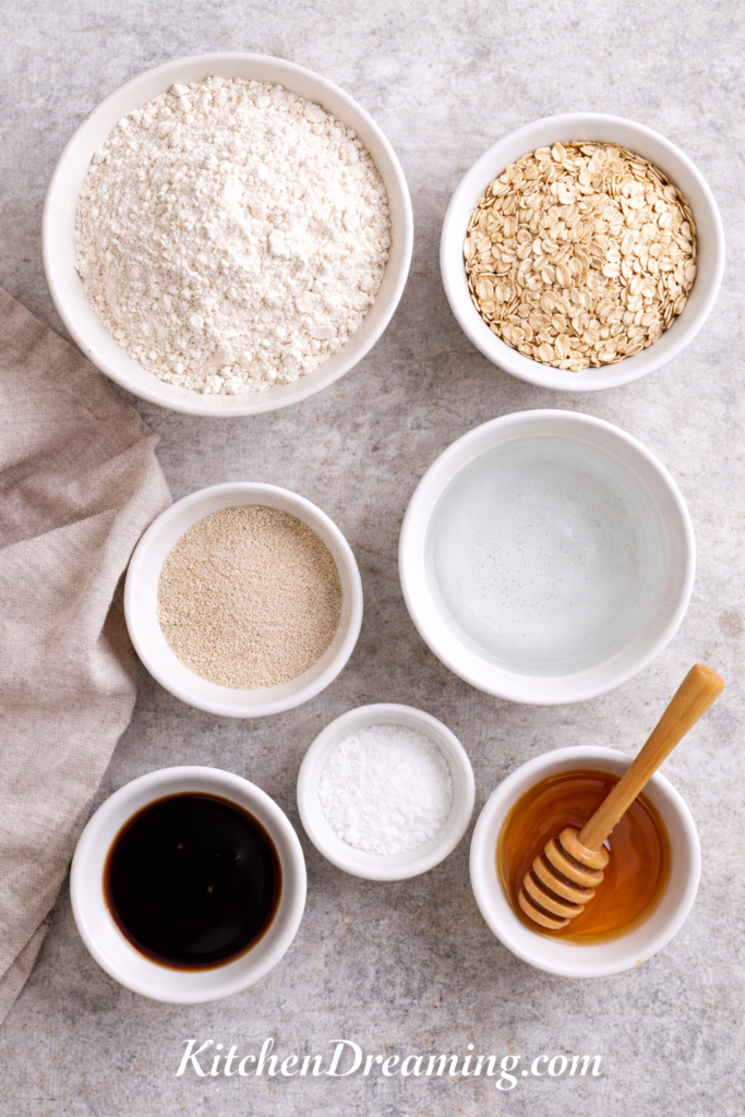 No Knead Oatmeal Bread (Easy Overnight Dutch Oven Recipe) 2 No knead oatmeal bread, ingredients measured in bowls for an overnight dough.