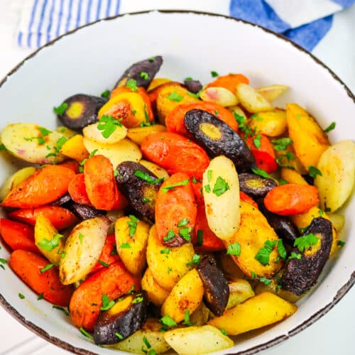 Roasted rainbow carrots have a tender texture with caramelized edges, offering a sweet and earthy flavor enhanced by the fresh brightness of parsley.