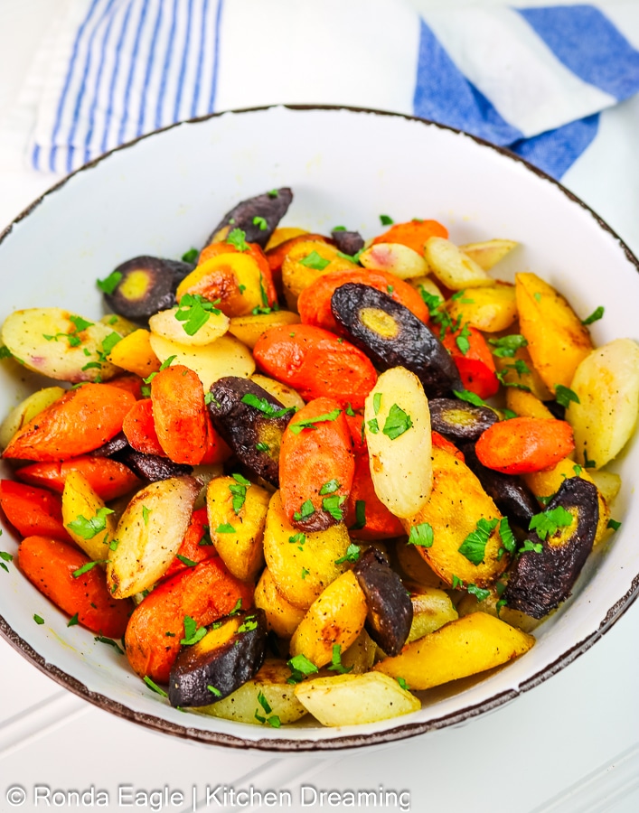 A bowl of roasted rainbow carrots ready to be served.