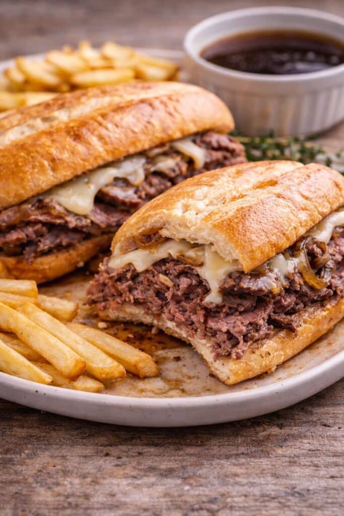 Easy Leftover Prime Rib French Dip Sandwich 4 Leftover Prime rib French dip sandwich served on a plate with au jus on the side