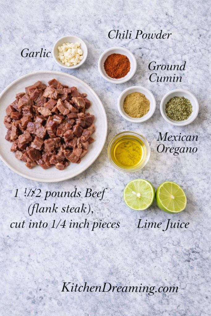 Mexican Street Tacos Recipe (Better Than Takeout) 3 Labeled ingredients for Mexican street tacos recipe marinade including lime juice, canola oil, garlic, chili powder, cumin, Mexican oregano, and flank steak.
