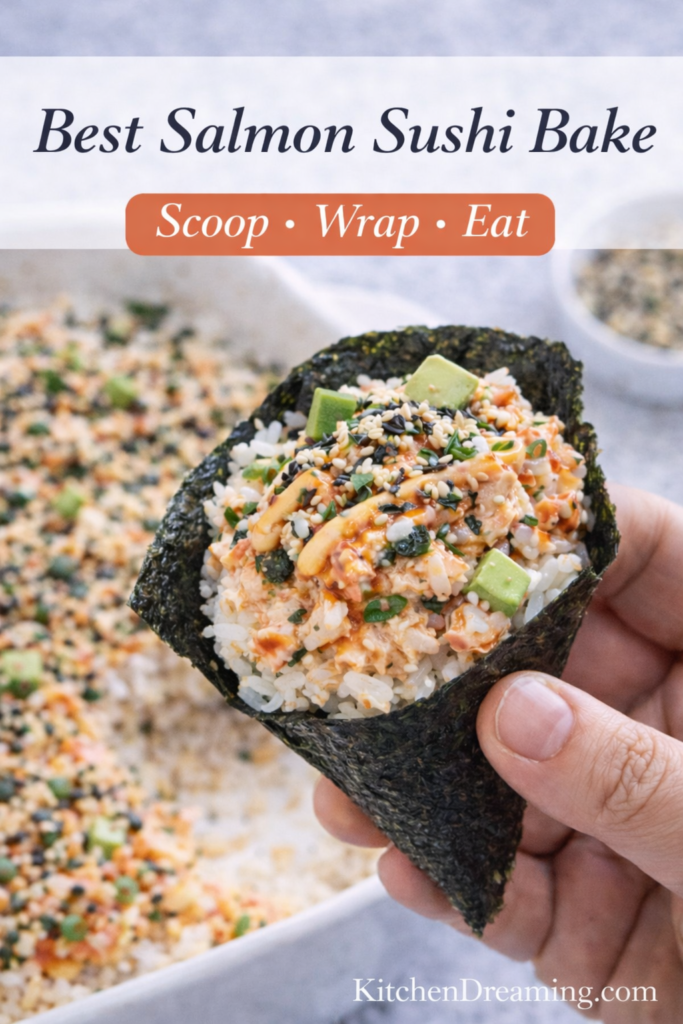 Salmon Sushi Bake Recipe (Easy, Creamy Sushi Bake) 11 Best salmon sushi bake recipe shown wrapped in nori cone held in hand with avocado and spicy mayo.