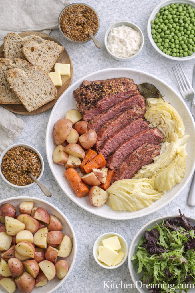 Crock Pot Corned Beef and Cabbage (Easy Slow Cooker Recipe) 4 Crock pot corned beef and cabbage served with bread and condiments.