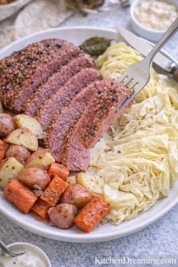 Instant Pot Corned Beef and Cabbage (Tender & Juicy) 6 Fork lifting instant pot corned beef and cabbage showing tender texture.