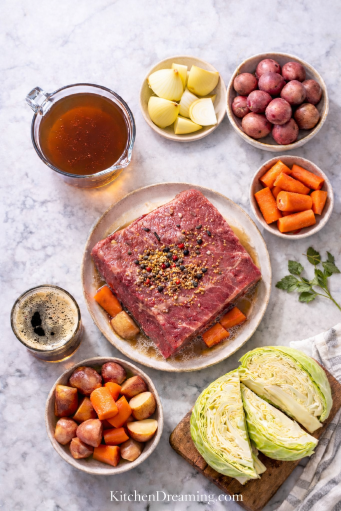 Traditional Corned Beef and Cabbage Recipe (Stovetop Boiled Method) 2 Ingredients for traditional corned beef and cabbage recipe on marble surface.
